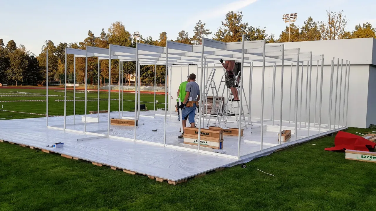 Steel frame and wall modules of a temporary outdoor event pavilion during construction in Poland